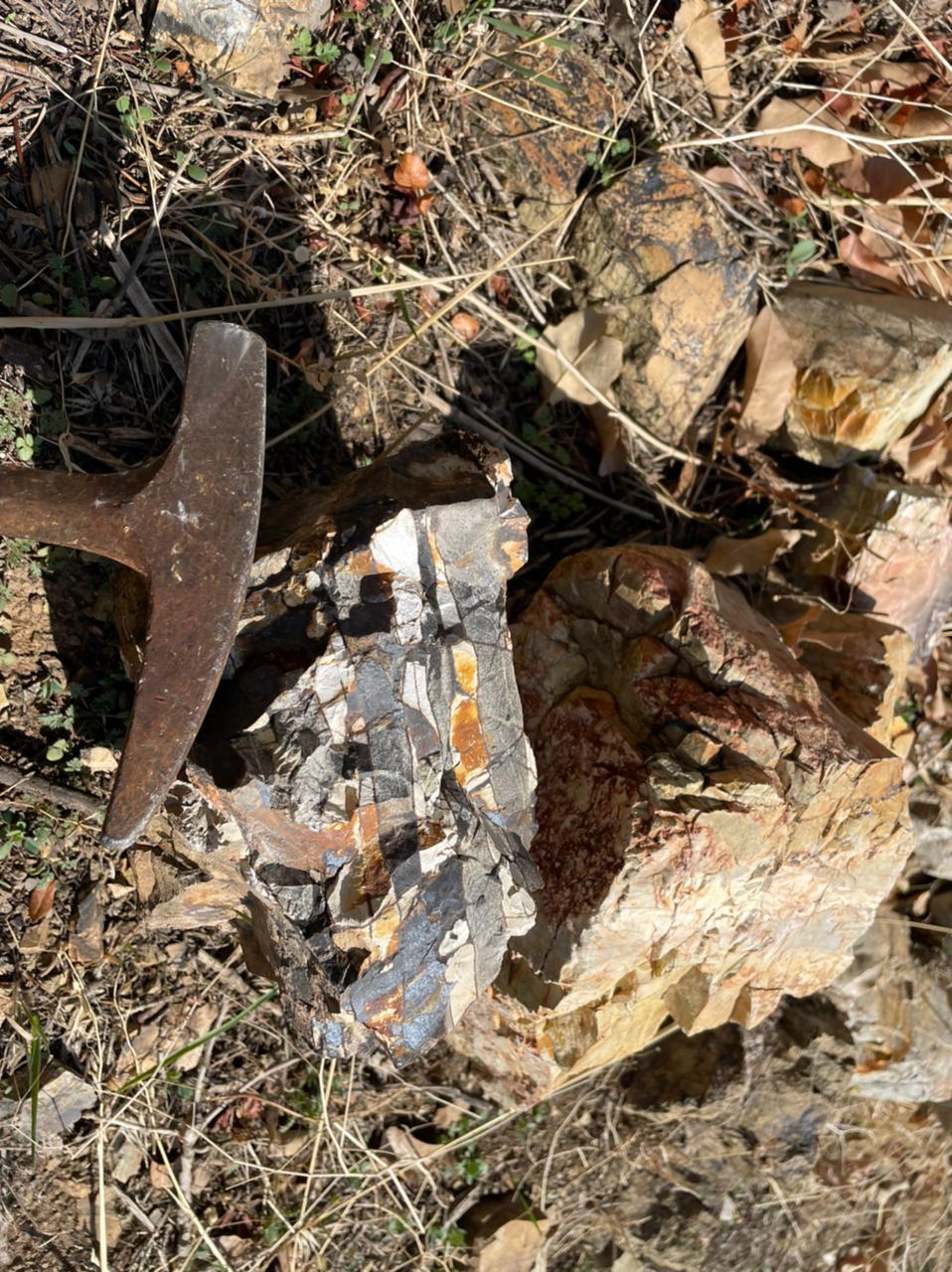Rock hammer on mineral layers